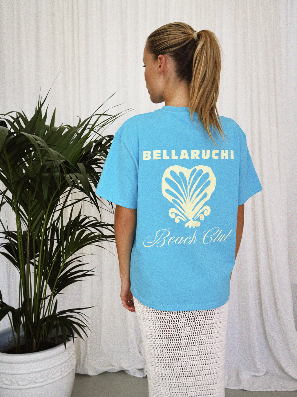 Blue T-shirt BELLARUCHI. Blue T-shirt with shell. Blue t-shirt yellow writing. Blue tshirt yellow back logo. BELLARUCHI Blue tee. Boxy Blue tee. Aqua Boxy Tee. Aqua Tee. 