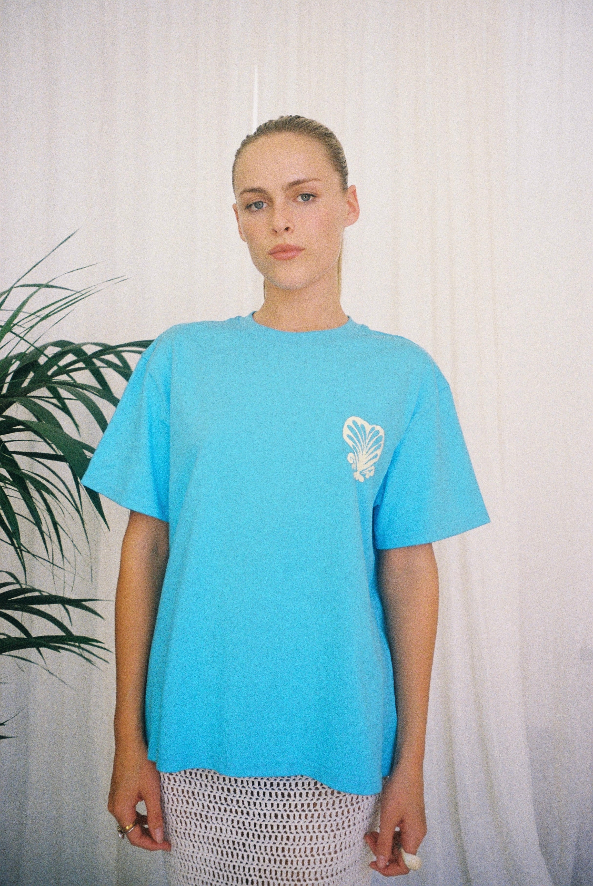Blue T-shirt BELLARUCHI. Blue T-shirt with shell. Blue t-shirt yellow writing. Blue tshirt yellow back logo. BELLARUCHI Blue tee. Boxy Blue tee. Aqua Boxy Tee. Aqua Tee. 