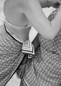 BELLARUCHI black and white photo of heritage sarong in cream. Our signature B print, and classic scarf design. Silk cotton travel sarong, perfect for vacation, beach to bar. 