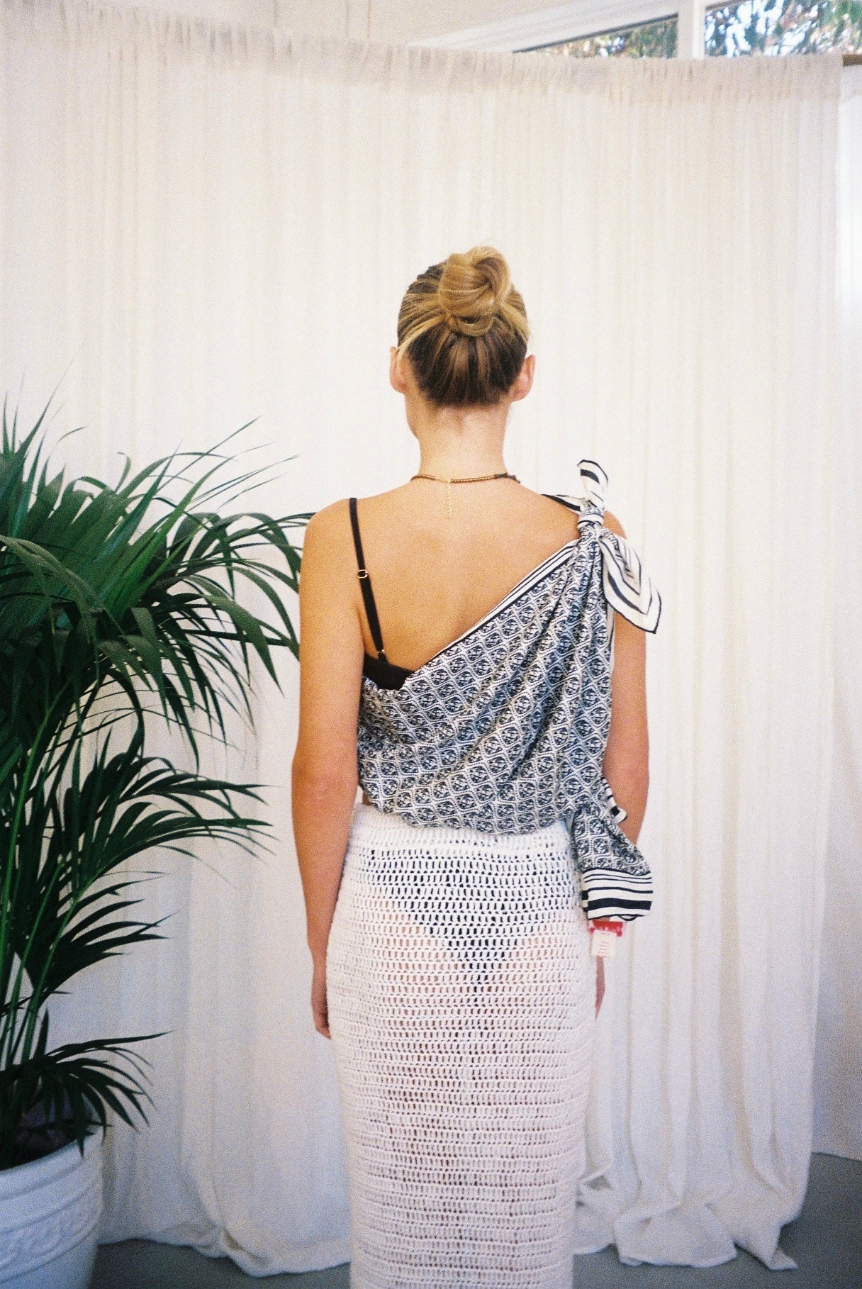 BELLARUCHI one shoulder top sarong back. BELLARUCHI sarong tied as one shoulder top.  BELLARUCHI Black and White logo Sarong. Black and white logo scarf. Silk Cotton Scarf. B logo Sarong. White and Black Pattern Sarong. Vacation Sarong. Travel Scarf. Travel sarong. 