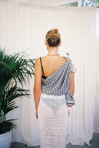 BELLARUCHI one shoulder top sarong back. BELLARUCHI sarong tied as one shoulder top.  BELLARUCHI Black and White logo Sarong. Black and white logo scarf. Silk Cotton Scarf. B logo Sarong. White and Black Pattern Sarong. Vacation Sarong. Travel Scarf. Travel sarong. 