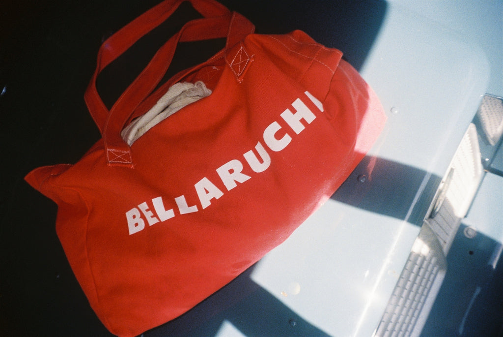 travel tote bag 
red bag, white writing 
BELLARUCHI logo